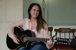 Scottish singer Sandi Thom seated with a guitar