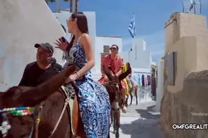 Women riding donkeys in Santorini