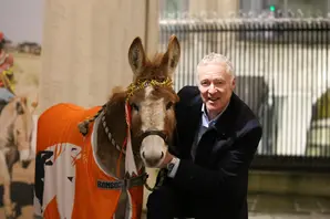 Rory Bremner with donkey at charity carol service