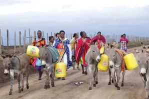 women and donkeys transporting waterPNG.png