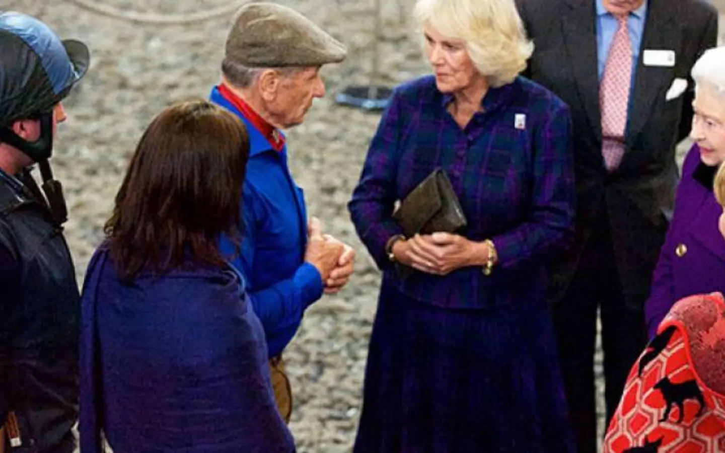 HRH The Queen stands with Queen Elizabeth II while talking to Monty Roberts
