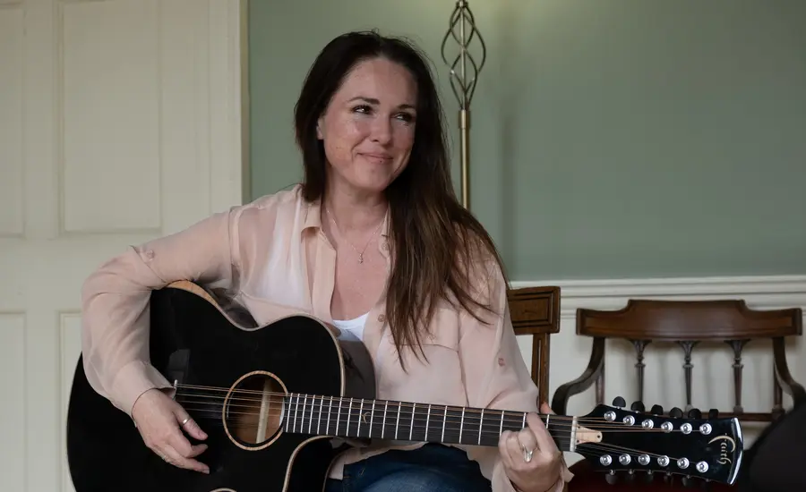 Scottish singer Sandi Thom seated with a guitar