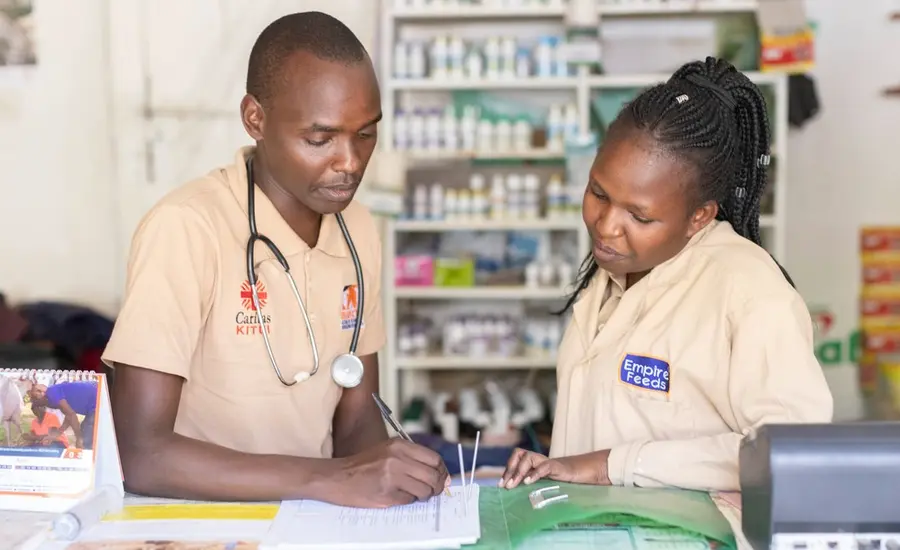 A vet mentors a trainee agrovet at a store in Kenya