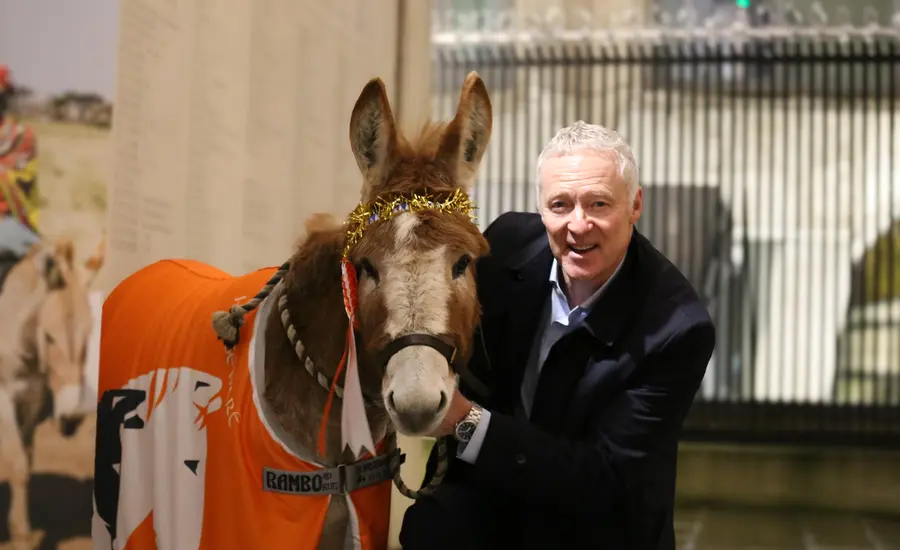 Rory Bremner with donkey at charity carol service