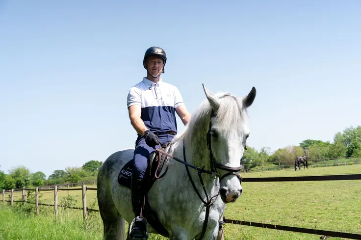 Sam Dracott riding a grey horse