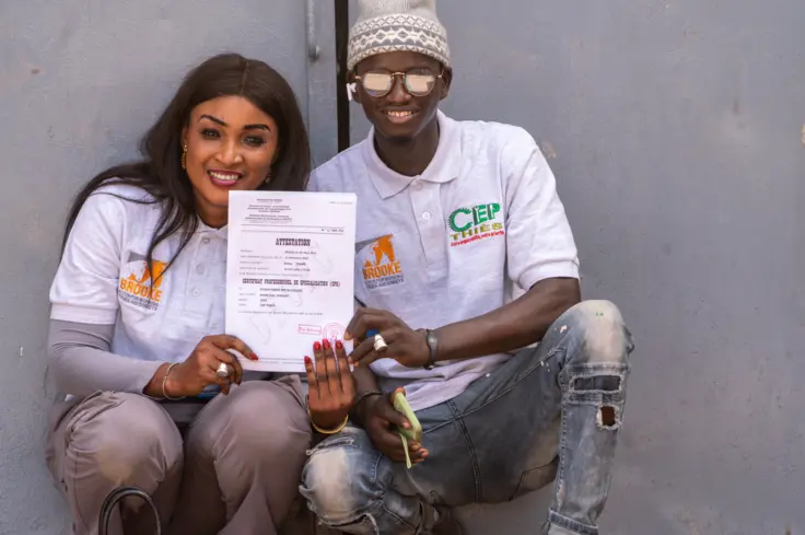 Students proudly show their certificates