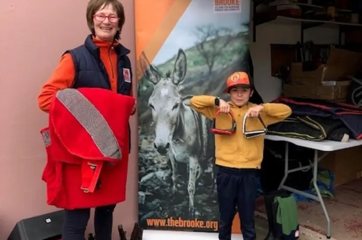 Attendees of a tack sale in Jersey in front of Brooke stand